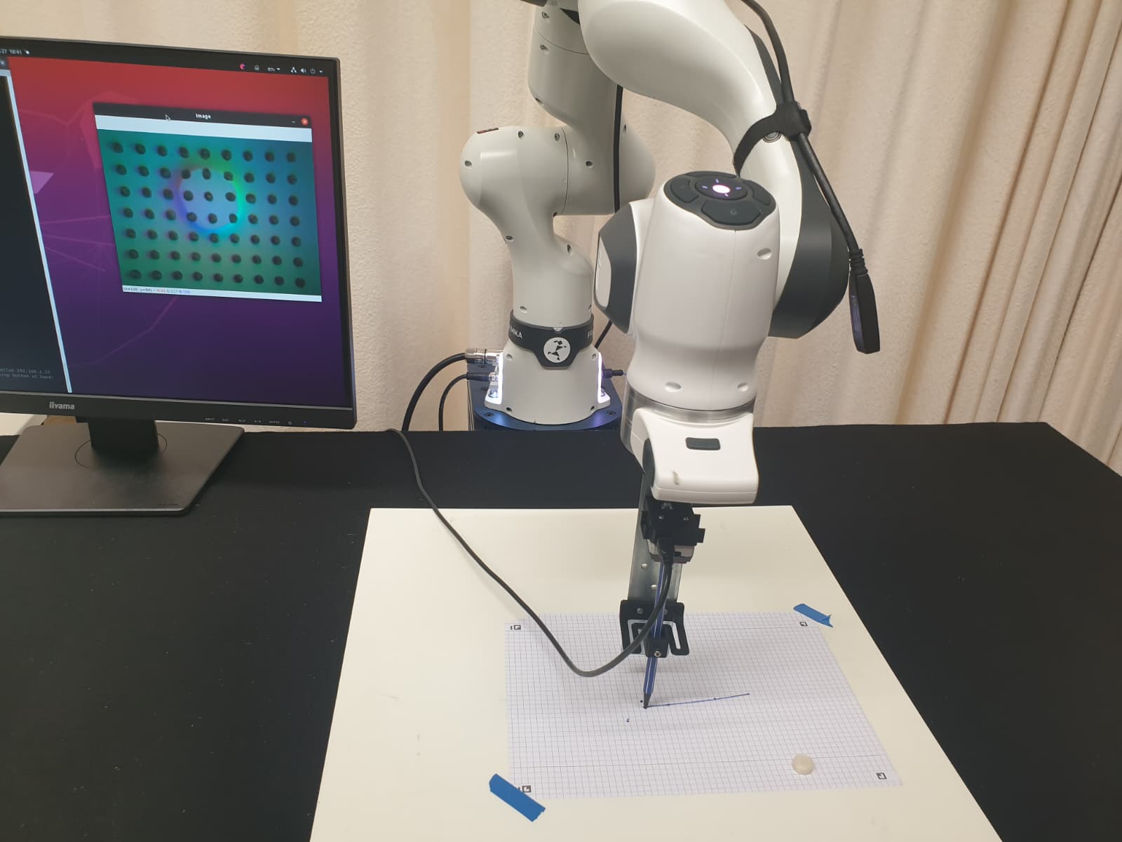 Franka robot arm drawing with a pen mounted through a visuo-tactile sensor