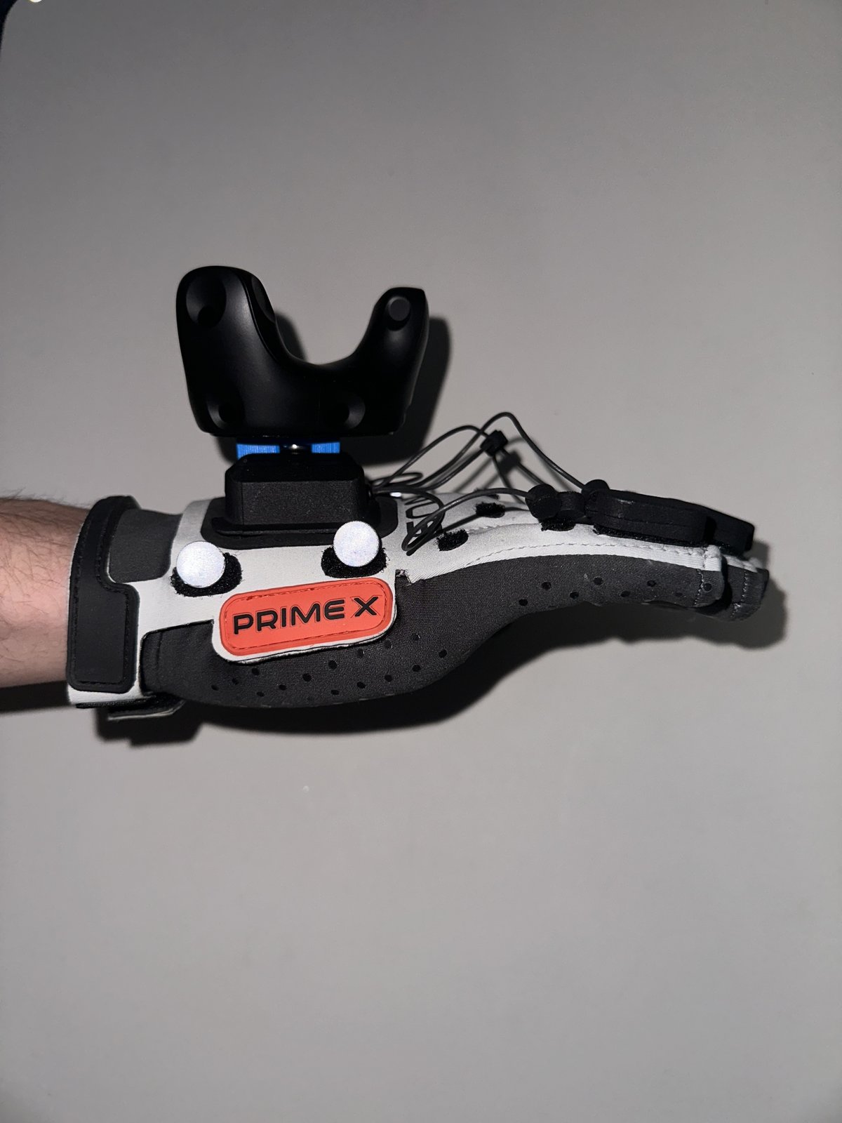 HTC Vive tracker mounted on a MANUS glove used for teleoperation